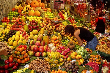 Western woman at market selecting from nutritious farm produce